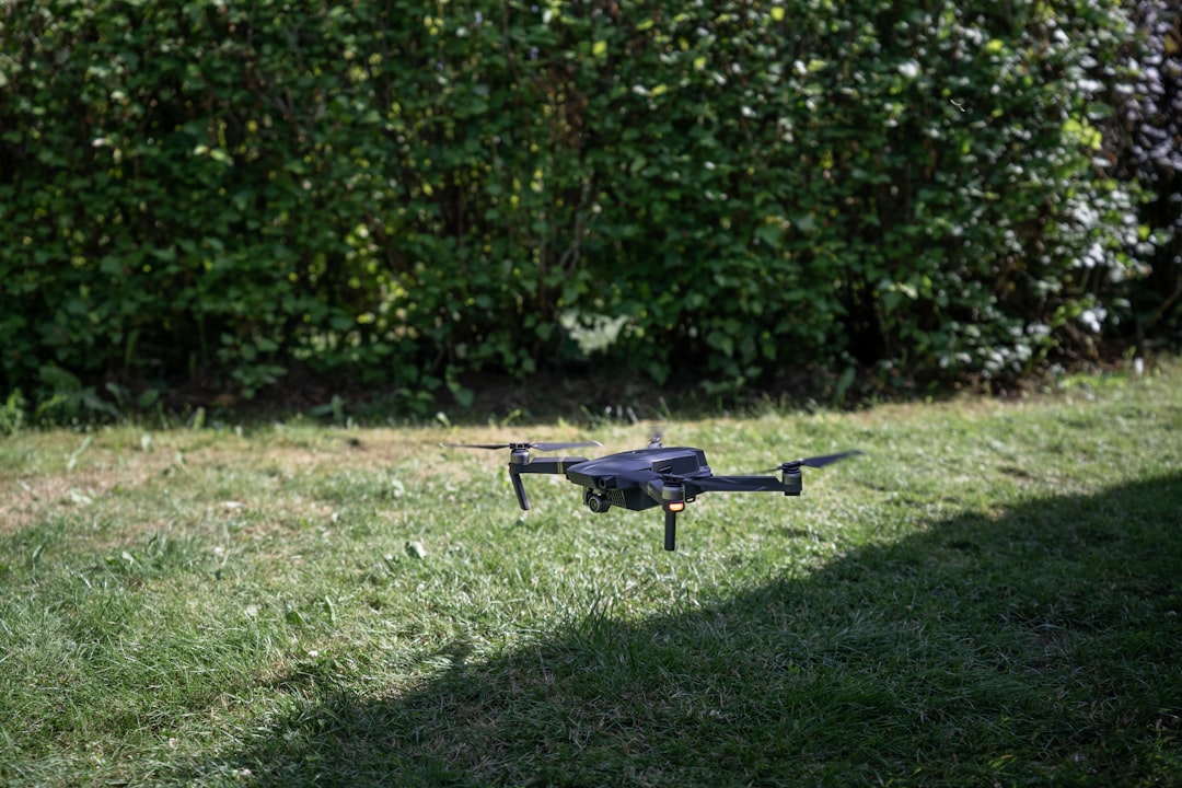 grey quadcopter lying above the ground