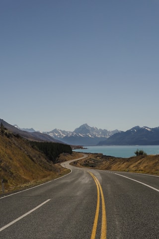 empty road near body of water