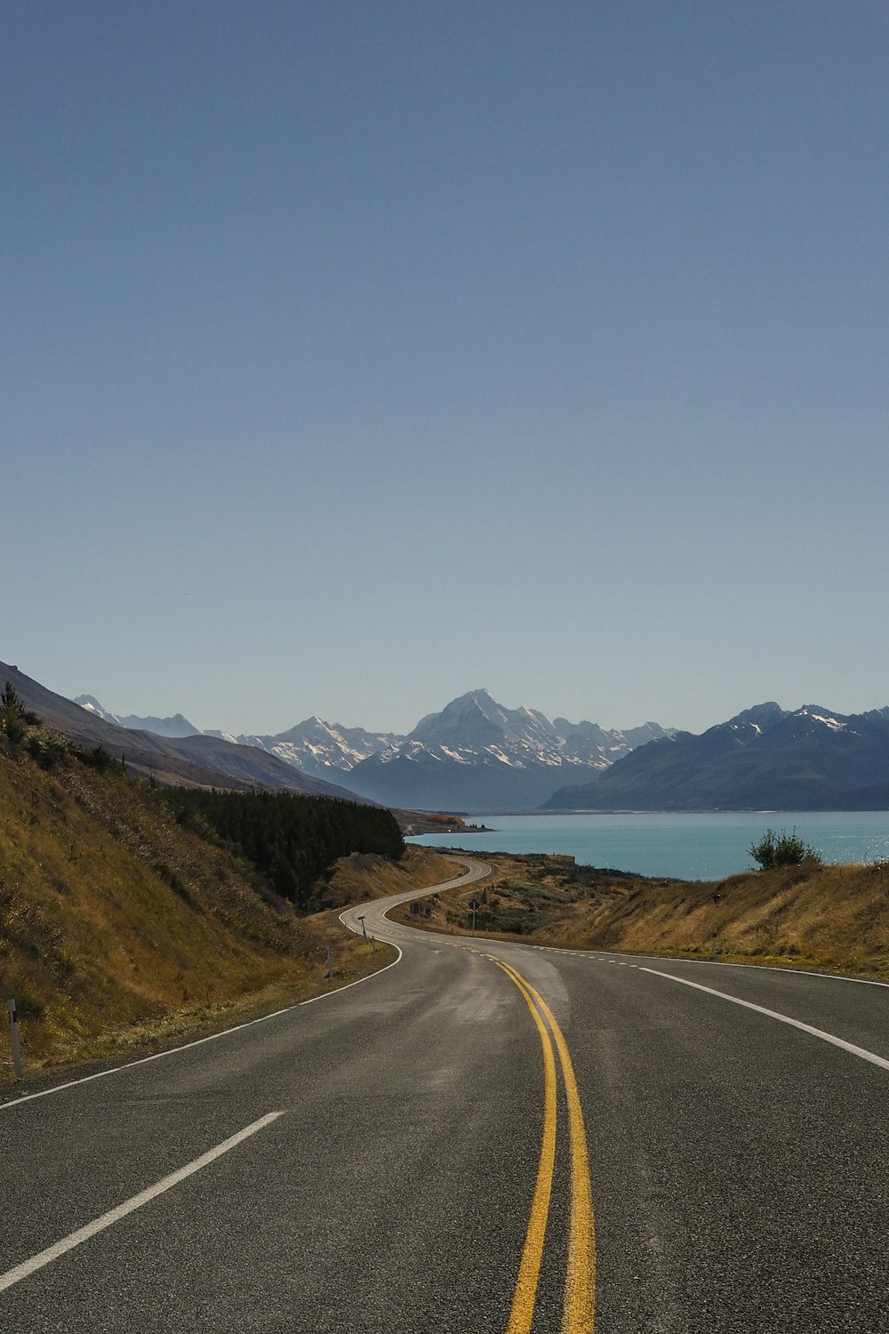 empty road near body of water