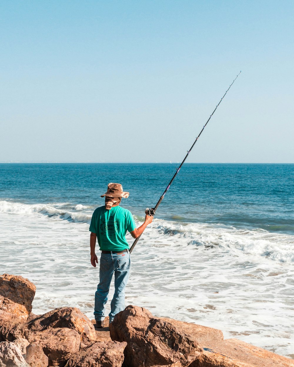 man standing near ocean