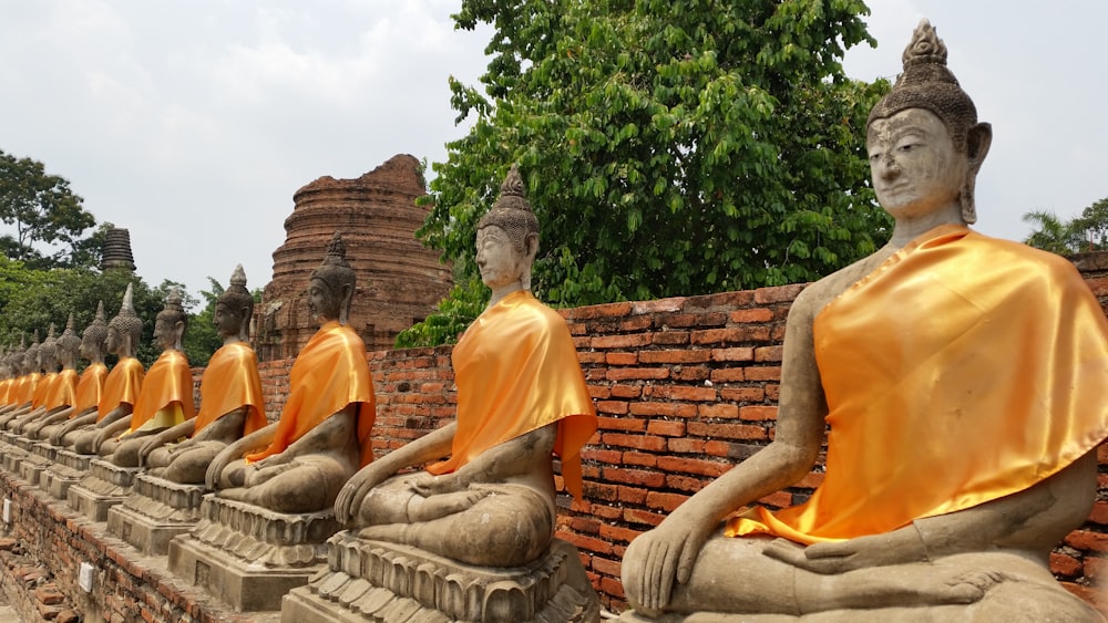 orange and brown buddha statue lot during daytime