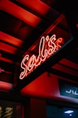 A colorful neon sign illuminating a dark room.