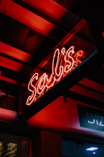 A vibrant neon sign glowing in a dark room.