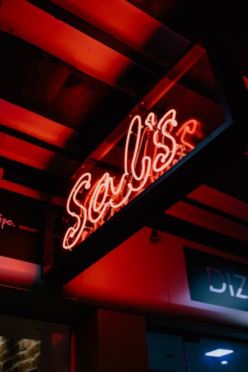 Close-up of the LED Monster 3D printed sign glowing softly in a dark room