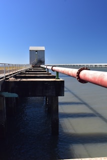 a large pipe sticking out of a body of water