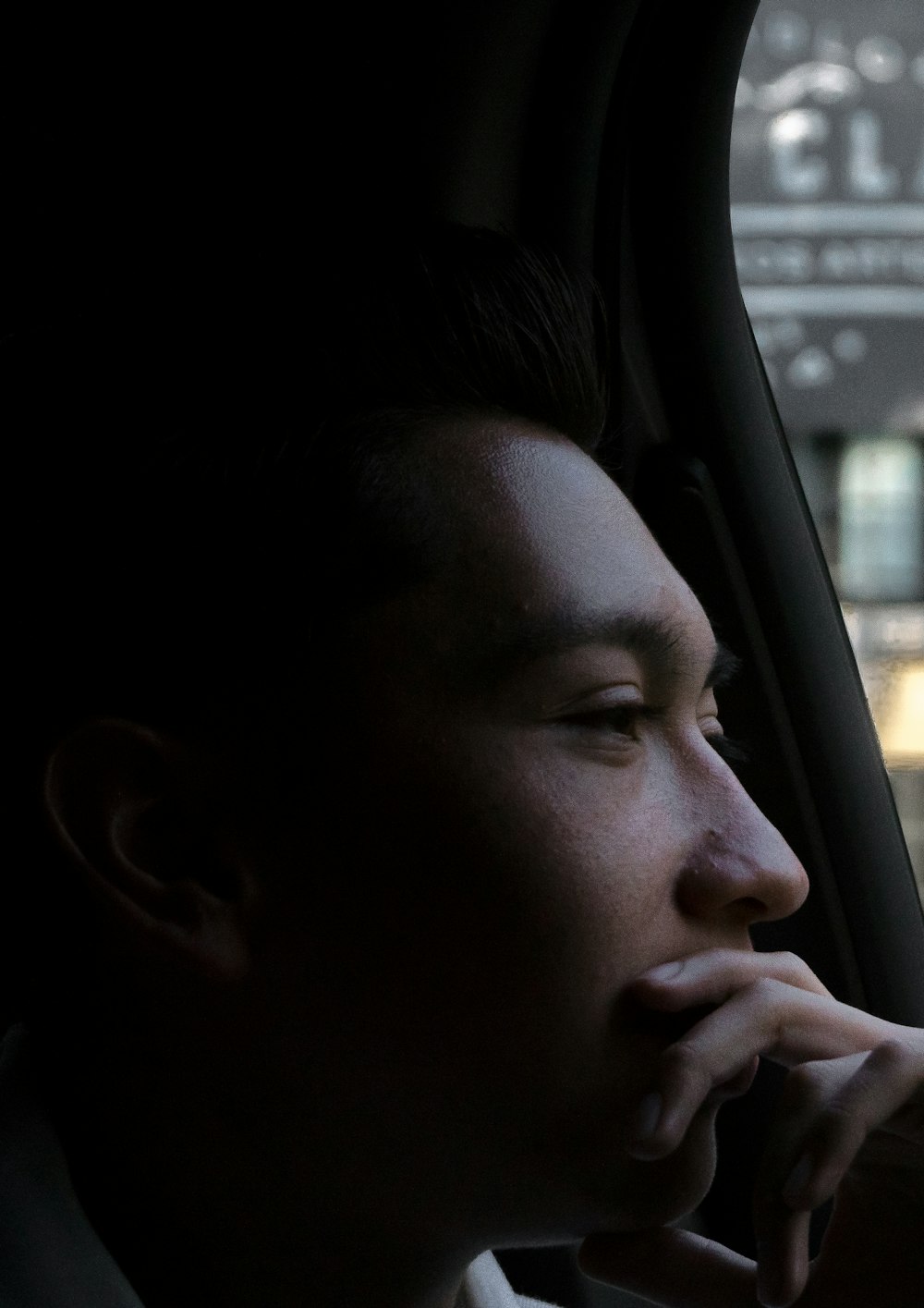 close-up photo of man looking outside vehicles window