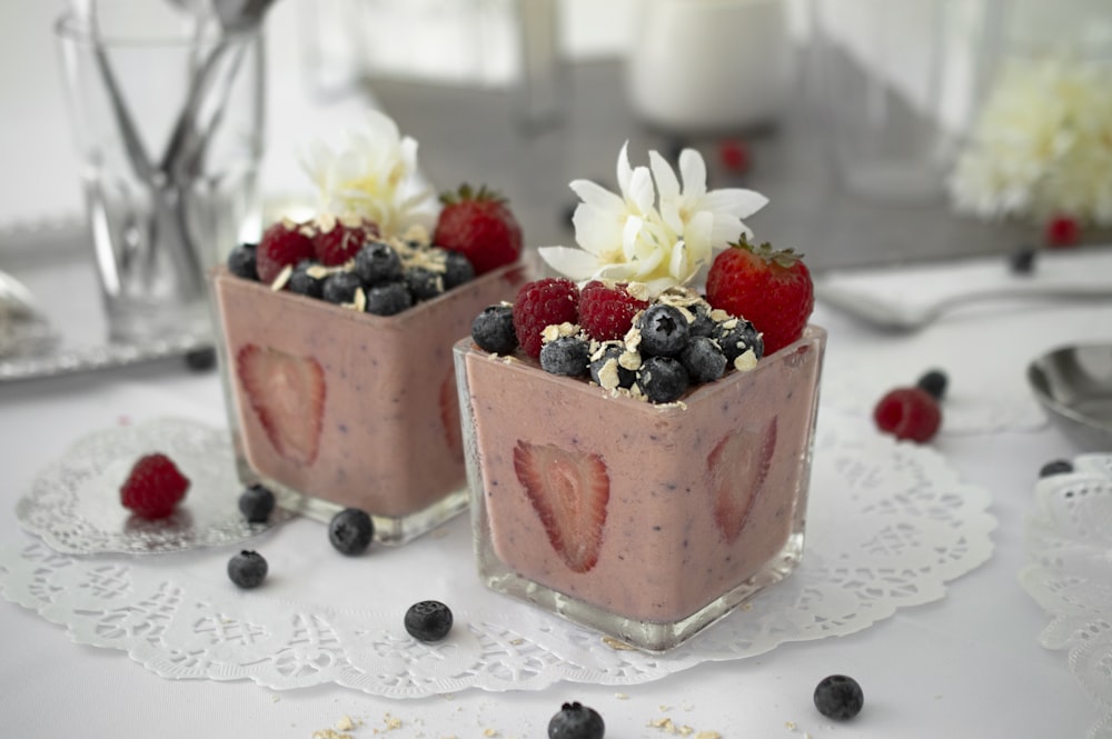 two glasses of blueberry and strawberry flavored desserts