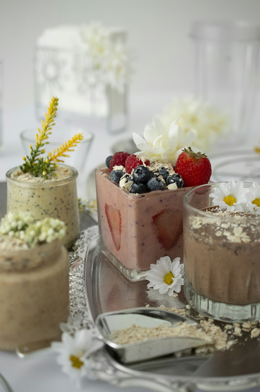 flowers and fruits on top of cups