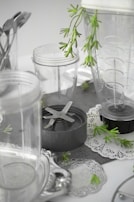 A compact kitchen blender surrounded by fresh fruits and vegetables.