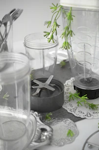 A sleek blender with a clear container and stainless steel base on a kitchen counter.