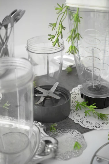 A sleek countertop blender surrounded by fresh fruits and vegetables, ready for a healthy meal prep.