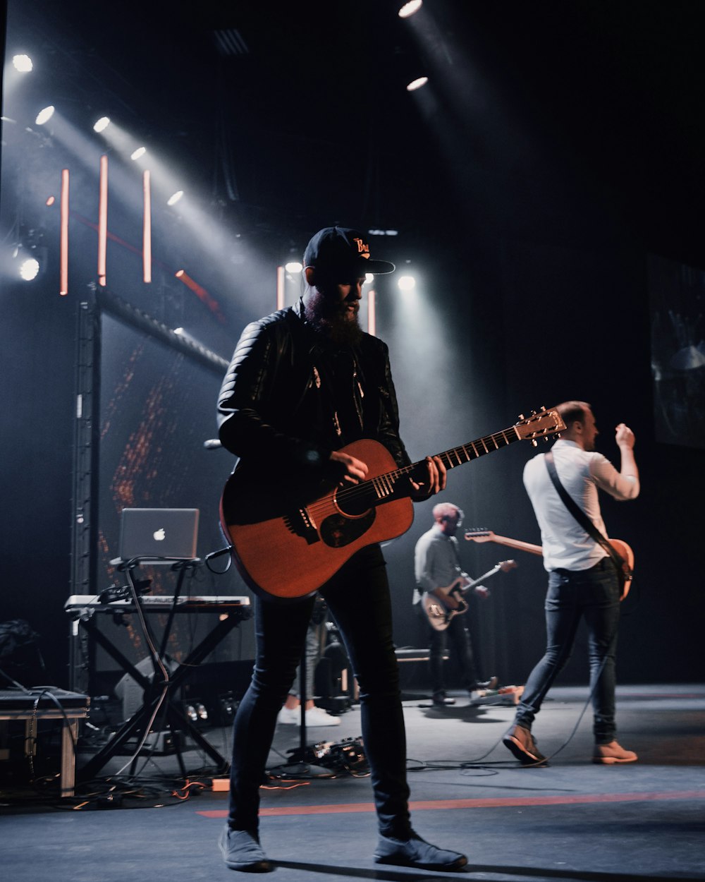 man standing and playing guitar