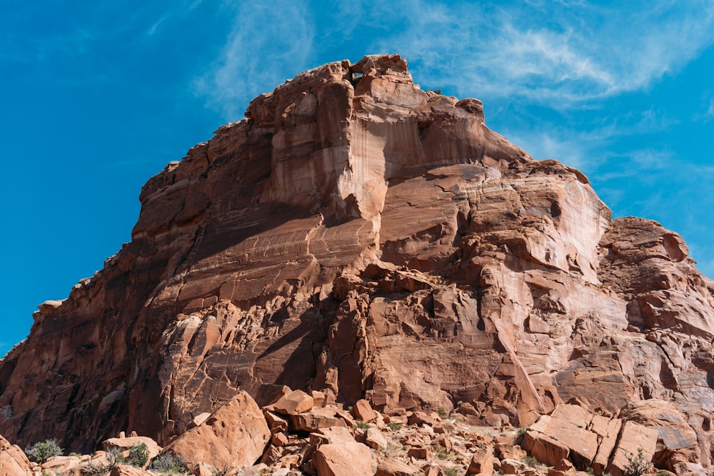 low angle photography of brown cliff under blue sky