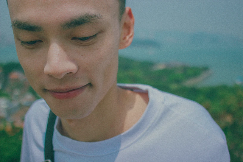 A serene portrait of a smiling client in a peaceful natural setting, reflecting calm and balance.