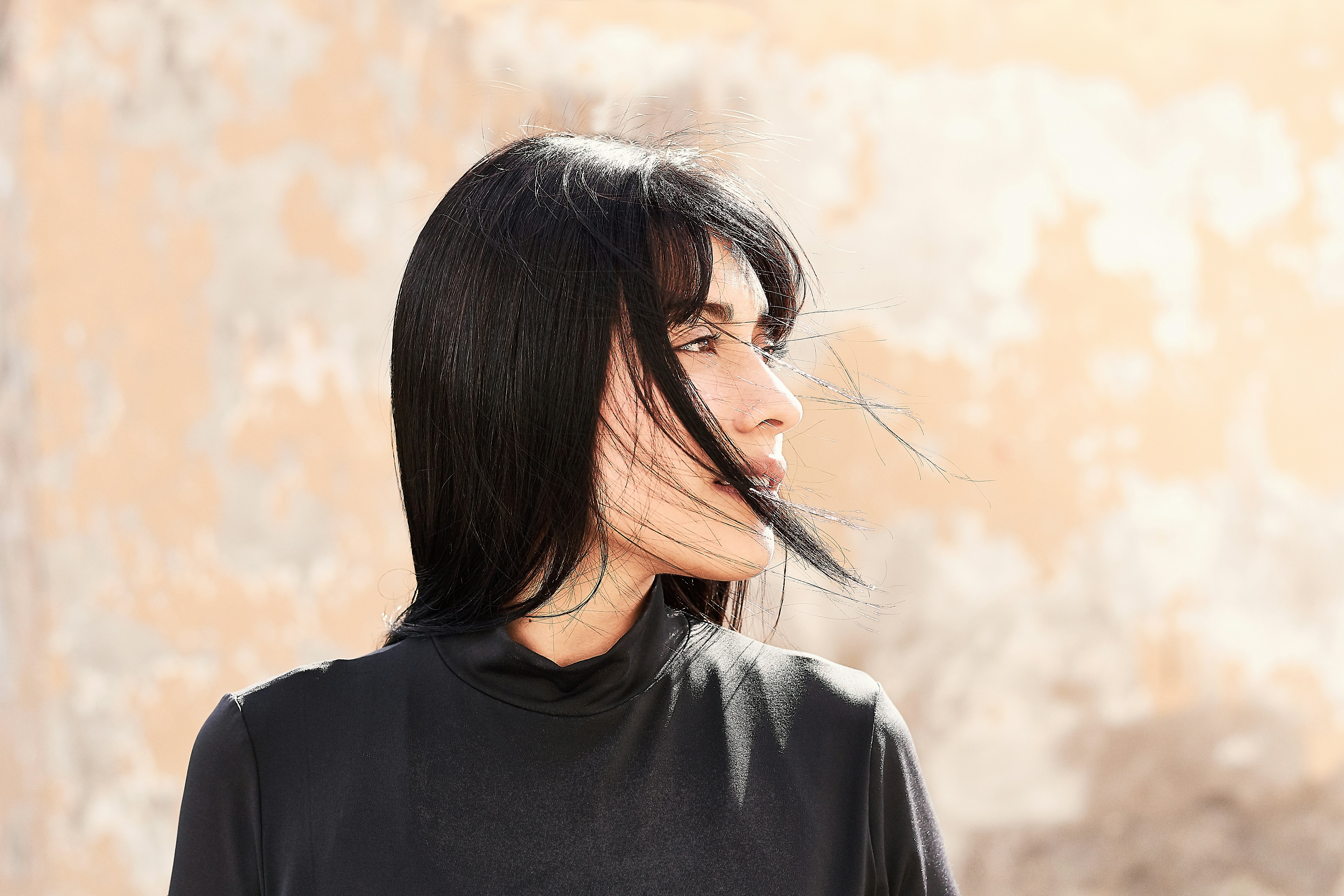 woman in black crew-neck top looking on her left