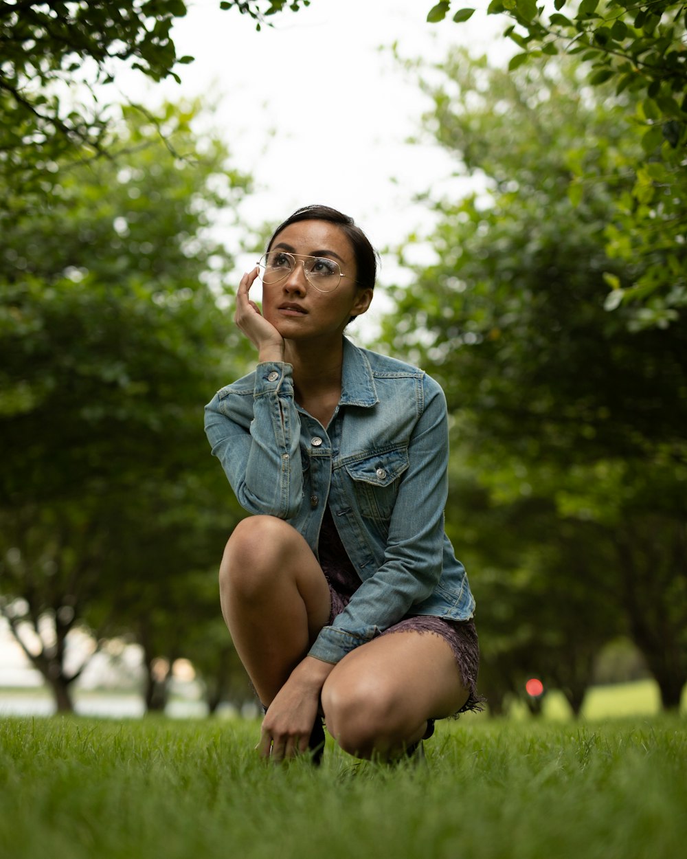 woman sitting on green grass