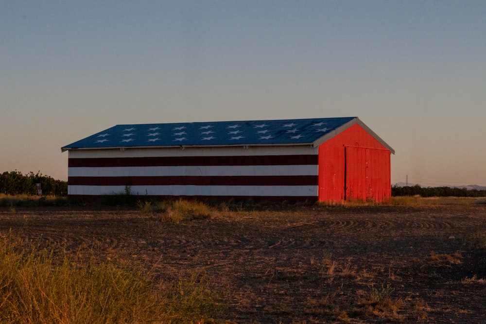 red and white barn during golden hour