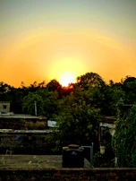 Sunset view over a completed water reservoir surrounded by natural vegetation.