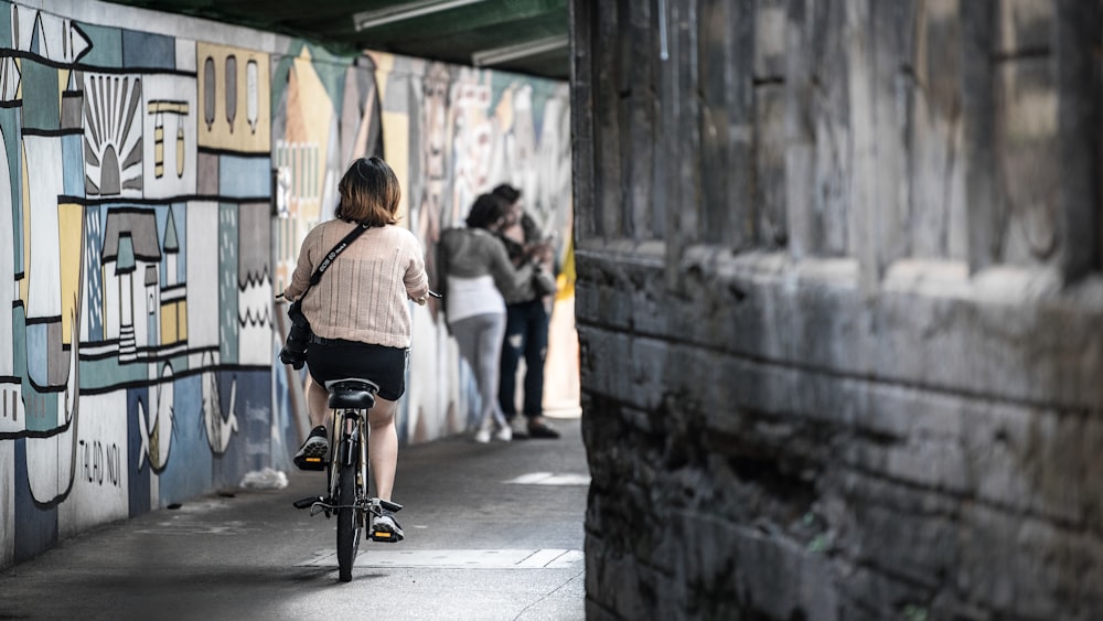 woman wearing pink shirt riding bicycle