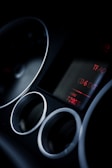 Close-up of a car radio screen going dark while playing a CD