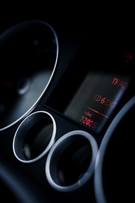 A car stereo display with red digital text indicating CD 6 and a mileage reading of 72035. The image is dark with focused light highlighting the display and air vents surrounding it.