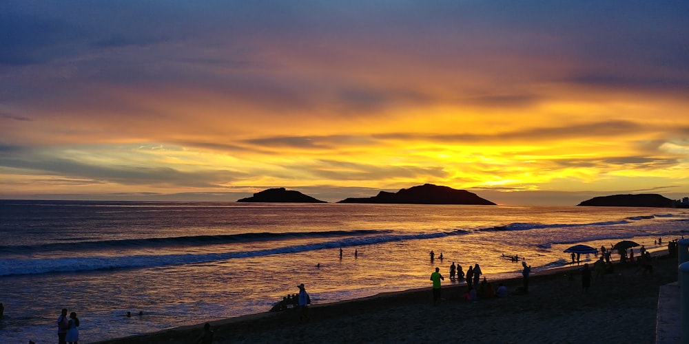 people at the beach during golden hour