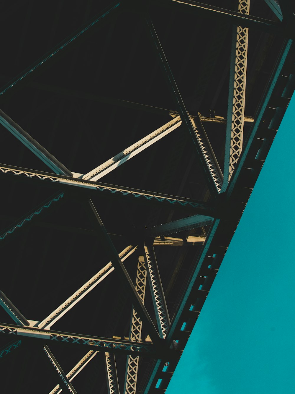 a close up of a metal structure with a blue sky in the background