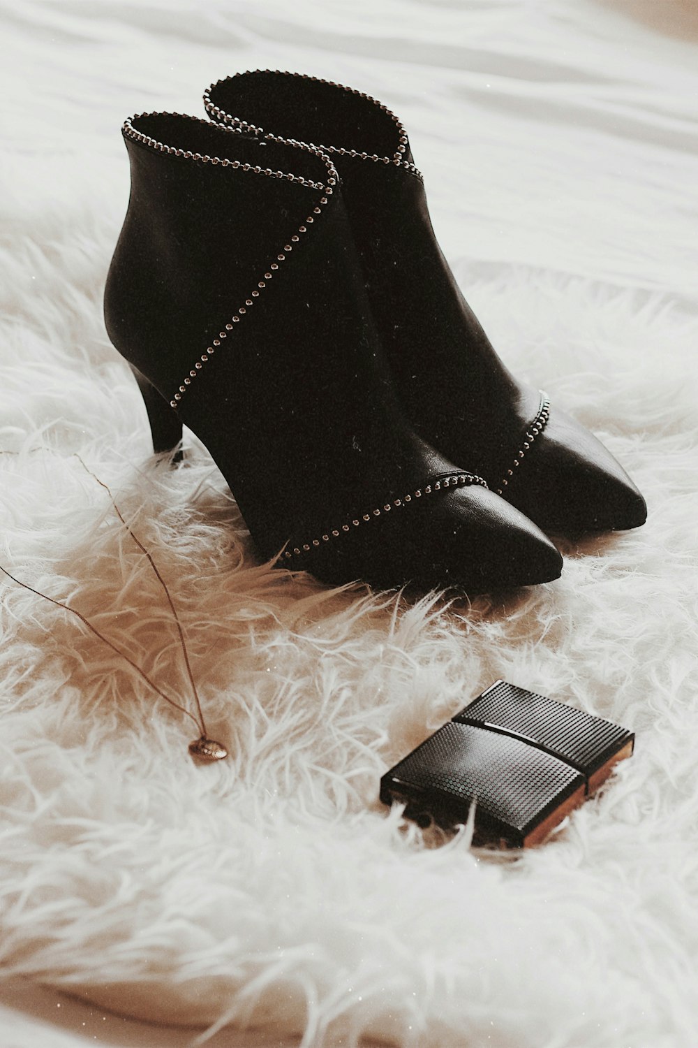 pair of black heeled booties