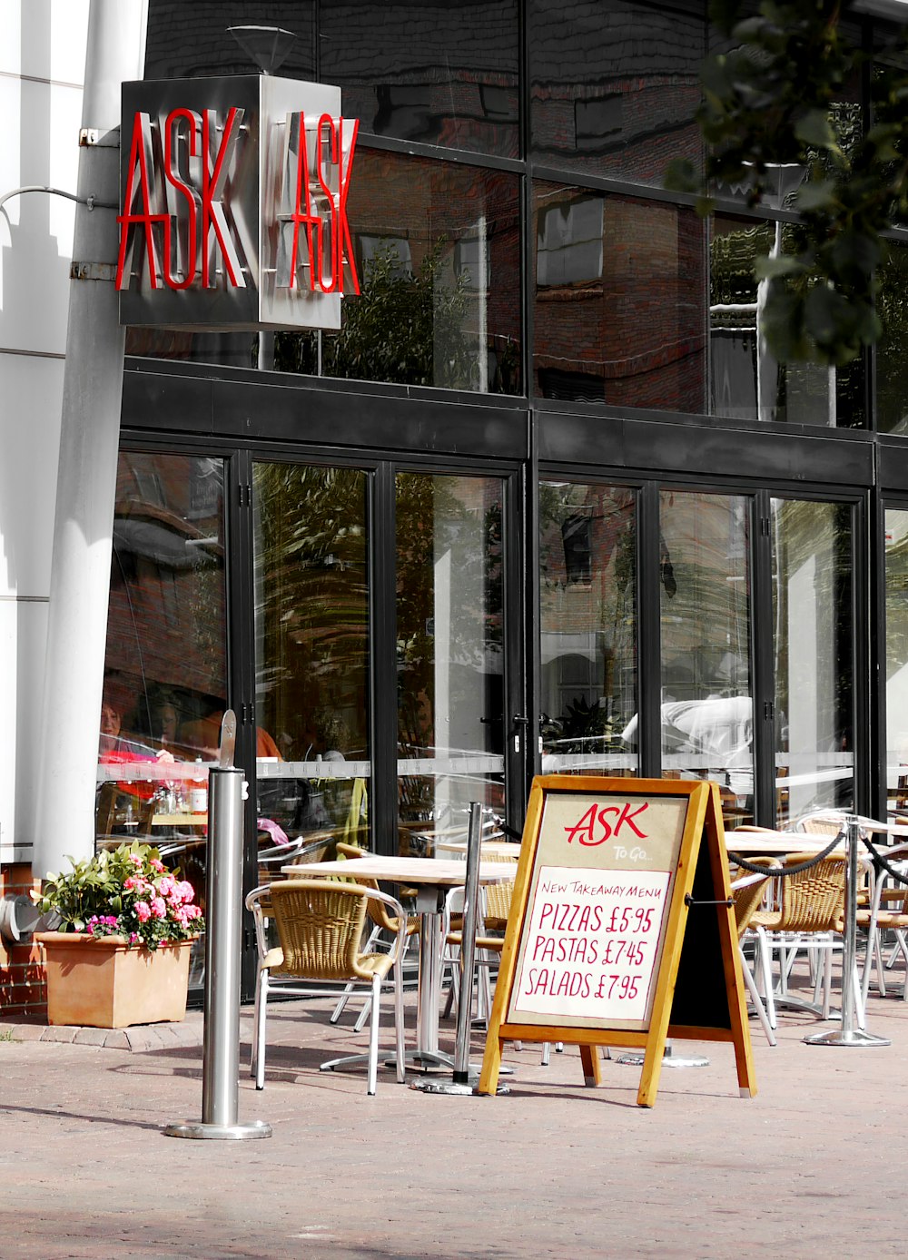 tables, chairs, and signage in front of store