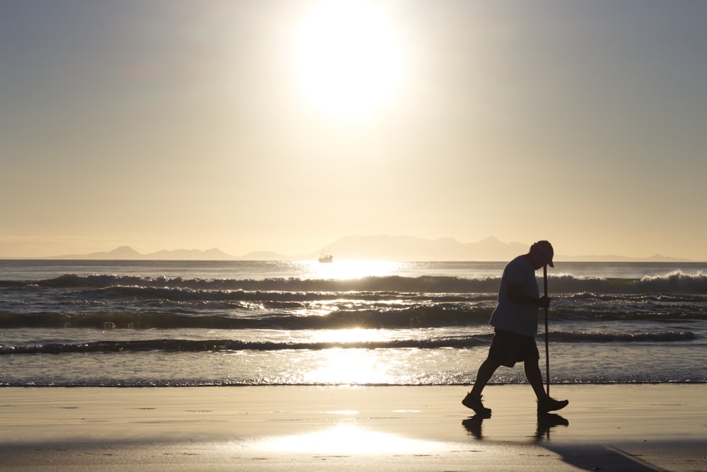 man walking on shore during daytime