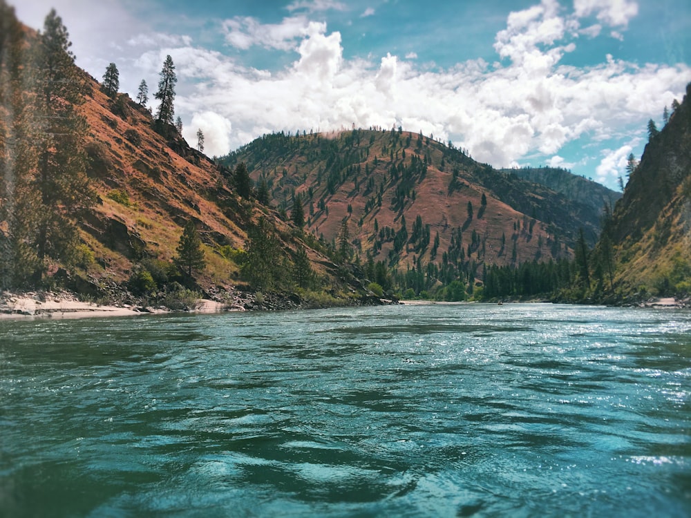 body of water near valley during daytime