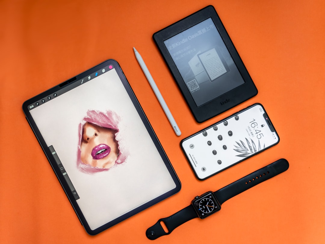 flat lay photography of two tablet computers, iPhone, and Apple watch