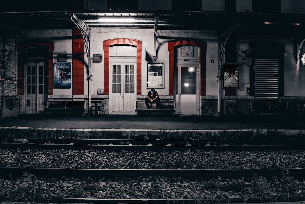 man sitting near wall