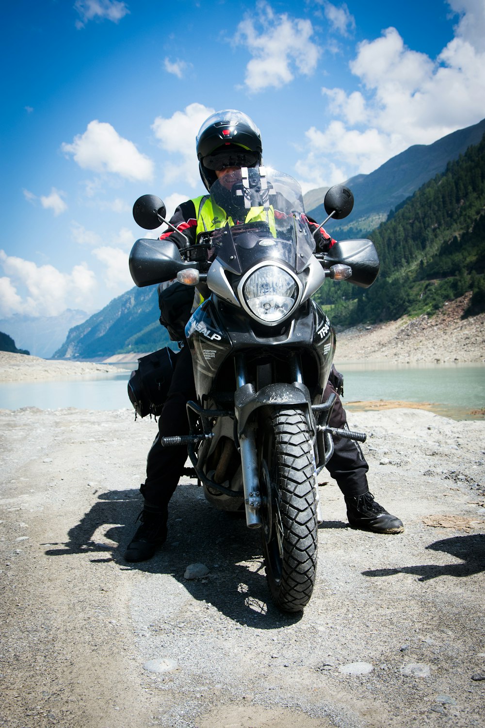 man riding motorcycle stopping at river side