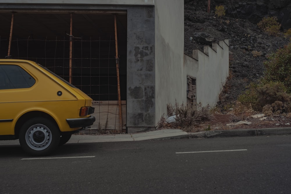 yellow car on road near building