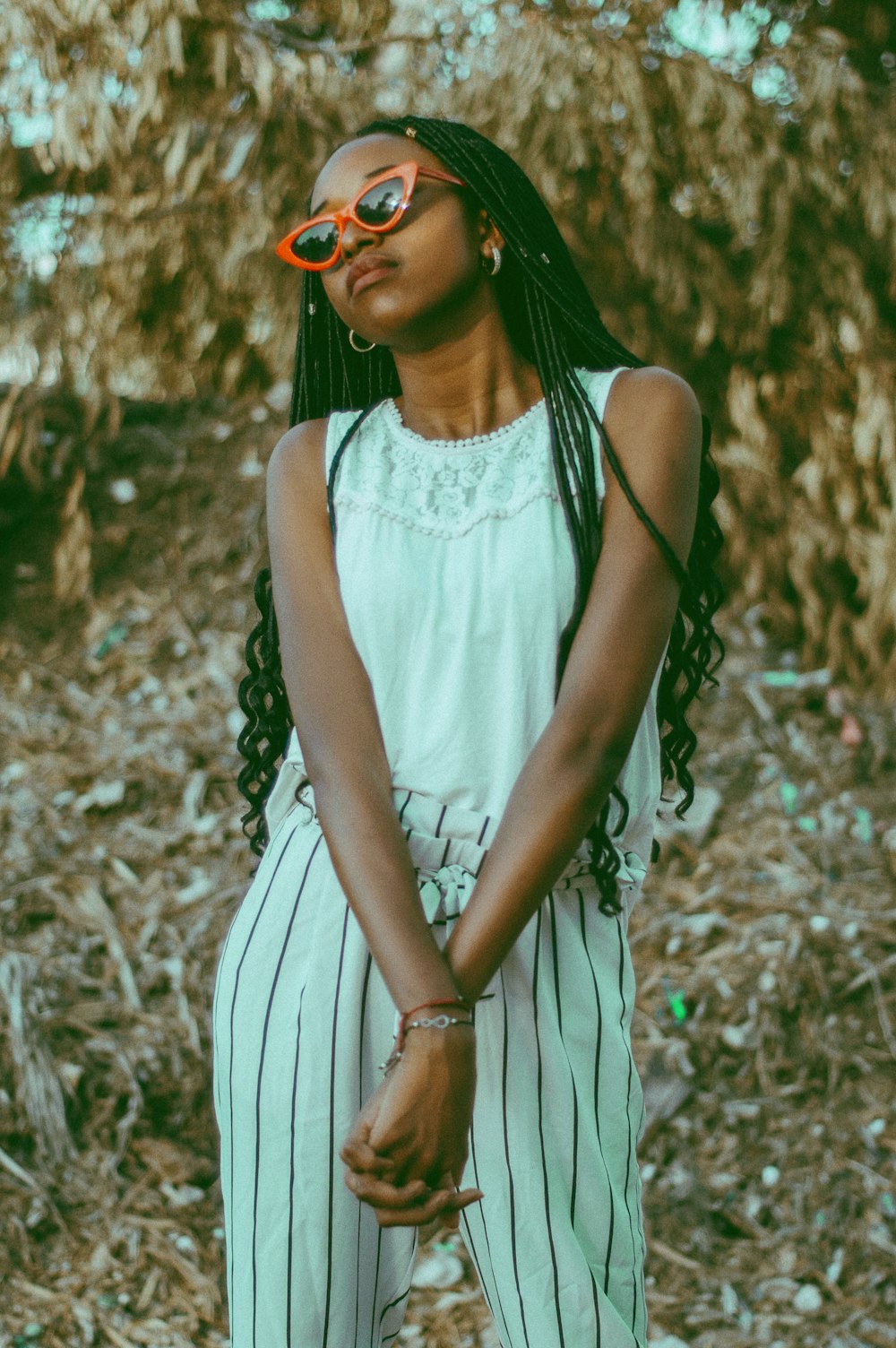 a woman in a white top and striped pants