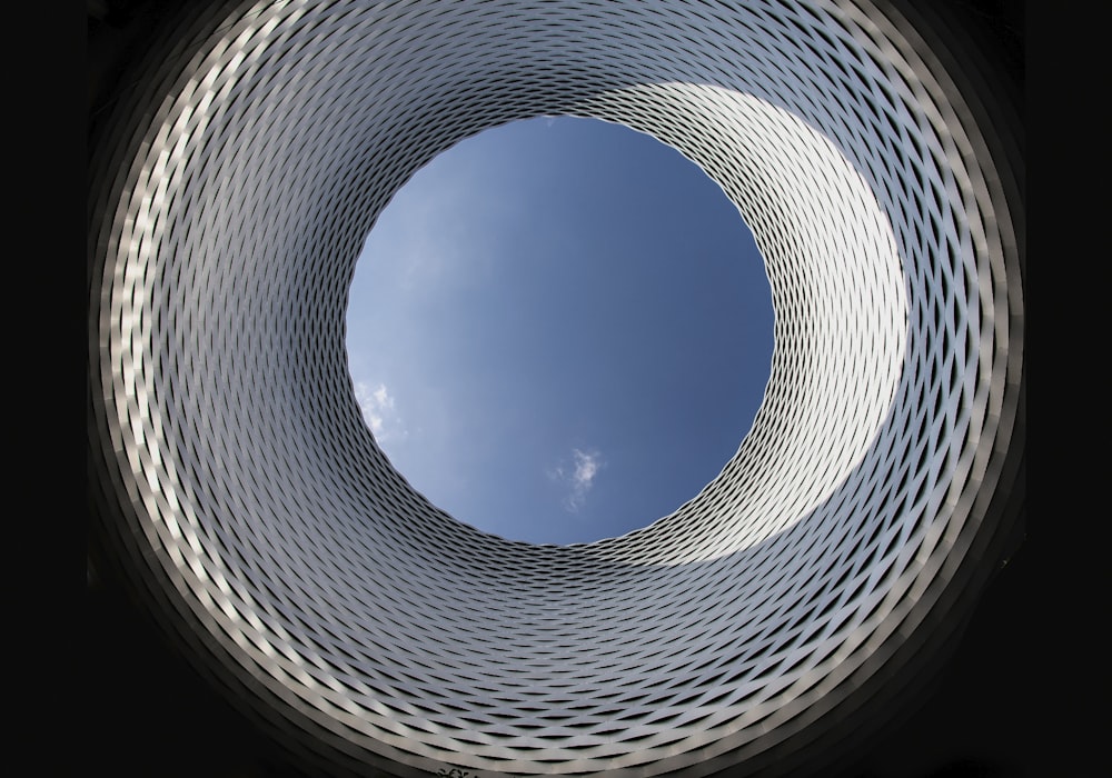 a circular view of a building with a blue sky in the background