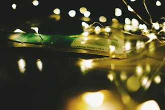 A warm, softly lit photo of hands holding a handwritten letter tied with a ribbon.