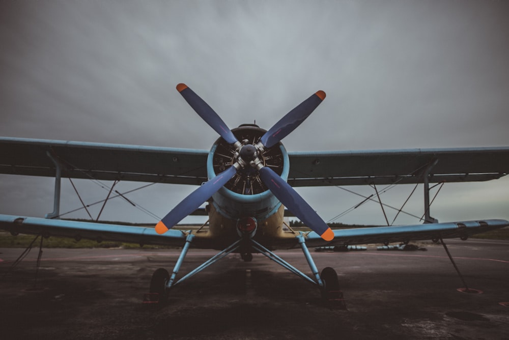 blue biplane during daytime