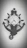 A black wall clock with a nautical theme is designed like a ship's wheel. The clock face has standard numerals and ornamental details resembling ship accoutrements. Below the clock is an anchor motif that complements the overall nautical design.