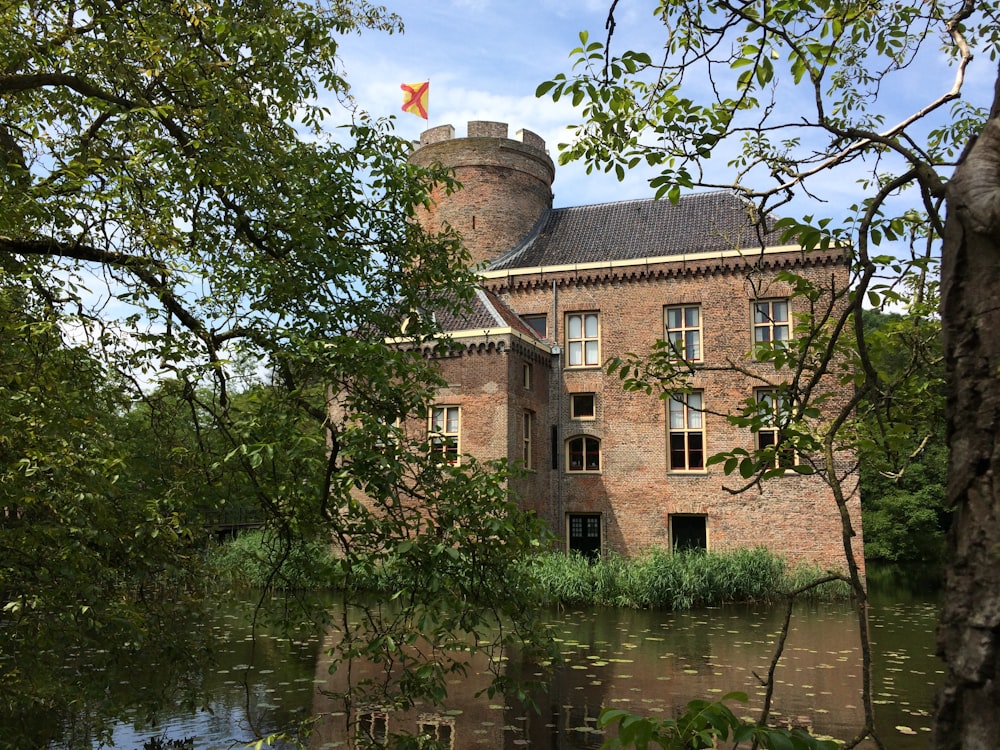 brown brick house near pond