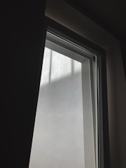 A freshly installed large window letting in natural light in a modern home.