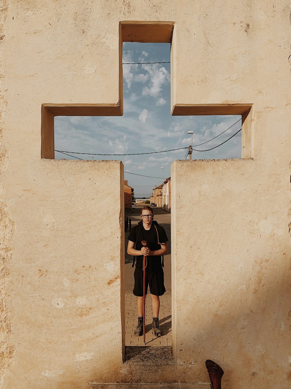 brown wall cross close-up photography