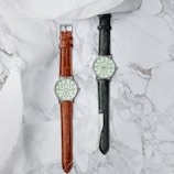 Minimalist display of premium watches arranged on a sleek marble surface.