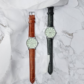Minimalist display of premium watches arranged on a sleek marble surface.