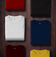 assorted color folded shirts on wooden panel