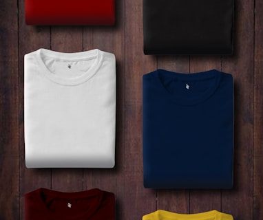 assorted color folded shirts on wooden panel