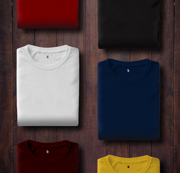 assorted color folded shirts on wooden panel