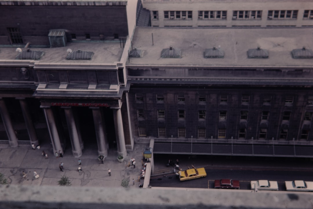 cars parked at roadside beside building