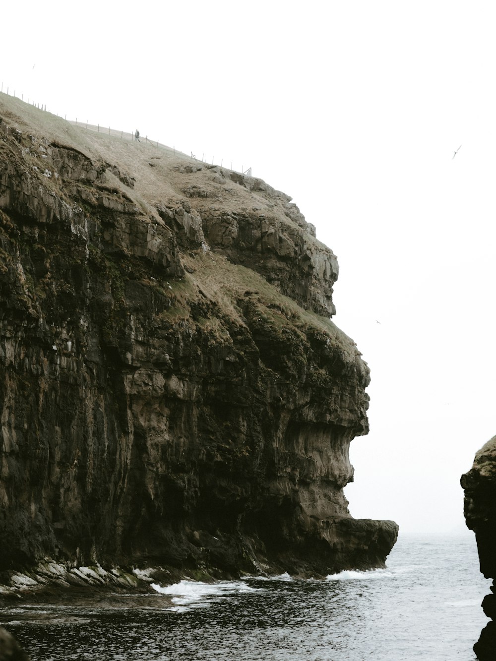 landscape photography of hill beside body of water